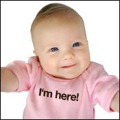 Baby with a shirt saying "I'm here!"